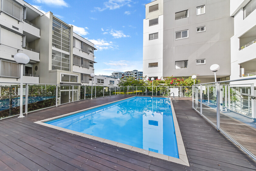 Rare Fully Furnished Apartment in resort style cul-de-sac living in private bayside residence with uninterrupted sparkling water views